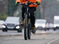 Most people (56%) in urban areas would support shifting investment from road building to fund active travel and public transport, a new survey suggests (Jacob King/PA)
