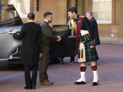 Ukrainian President Volodymyr Zelensky is greeted by Lieutenant Colonel Johnny Thompson, equerry to King Charles III, as he arrives for an audience with the King at Buckingham Palace (Kirsty O’Connor/PA)