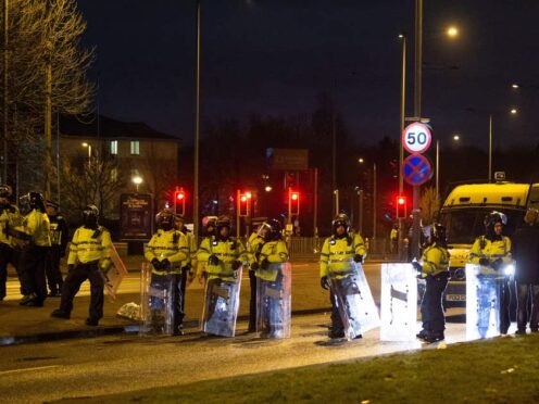 Police in riot gear after a demonstration outside the Suites Hotel in Knowsley, Merseyside (Peter Powell/PA)