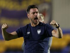 AFC Wimbledon manager Johnnie Jackson celebrates the win after the Carabao Cup first round match at the Cherry Red Records Stadium, London. Picture date: Wednesday August 9, 2023.