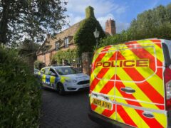 A property in Lady’s Drove, Emneth, Norfolk, is sealed off by police after a woman was found dead (Sam Russell/ PA)