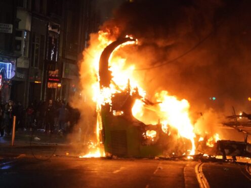 A bus on fire on O’Connell Street in Dublin city centre after violent scenes unfolded following an attack on Parnell Square East (PA)