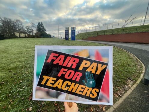 Signage on the picket line during a protest for teacher pay (Claudia Savage/PA)