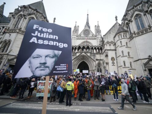 Supporters of Julian Assange gathered outside the Royal Courts of Justice in London (PA)
