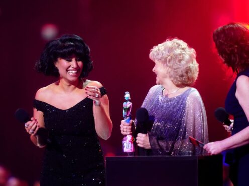 Raye on stage after winning the award for Song of the Year with a victim of the Post Office scandal (James Manning/PA)
