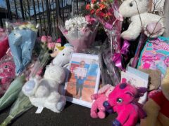 Flowers and toys left near the home of 10-year-old Shay Kang (Matthew Cooper/PA)