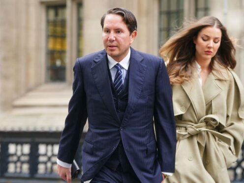 James Stunt arrives with partner Helena Robinson at the Rolls Building in London on Wednesday (Victoria Jones/PA)