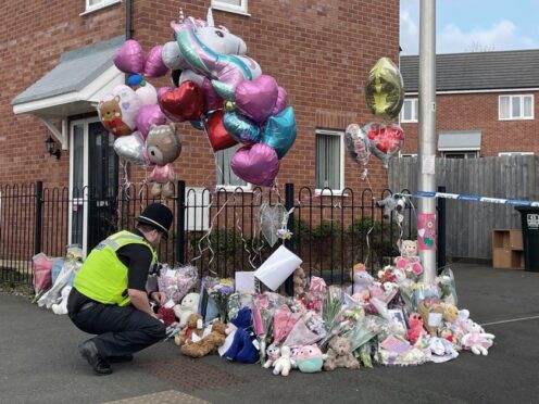Floral tributes are left at the entrance to Robin Close in Rowley Regis (Matthew Cooper/PA)