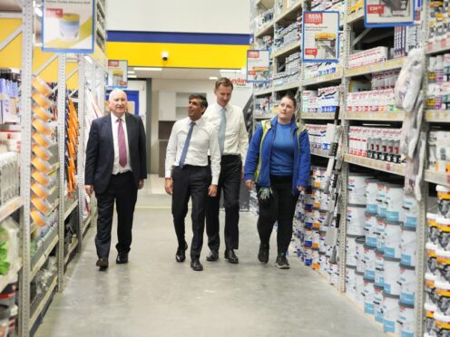 CEO of Selco Howard Luft, Prime Minister Rishi Sunak, Chancellor of the Exchequer Jeremy Hunt during a visit to a builders merchant in London (Kirsty Wigglesworth/PA)