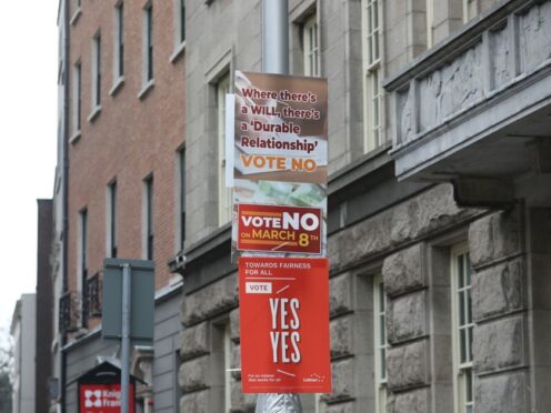 Placards in Dublin, as Ireland holds referenda on the proposed changes to the wording of the Constitution relating to the areas of family and care (Gareth Chaney/PA)