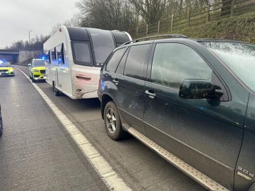 An 11-year-old boy was arrested after being stopped by police at the wheel of a BMW towing a suspected stolen caravan on the M1 (North Yorkshire Police/PA)