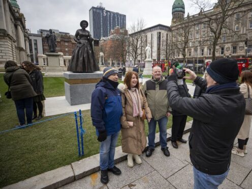 People taking a photo of Mary Ann McCracken during the unveiling of the statue with Winifred Carney (Liam McBurney/PA)