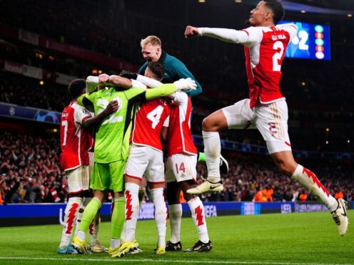 Arsenal players celebrate after winning the penalty shoot-out of the UEFA Champions League Round of 16 (Zac Goodwin, PA)