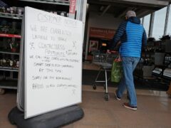 A handwritten sign outside a Sainsbury’s store in Cobham informing customers of technical issues affecting the supermarket chain (Yui Mok/PA)
