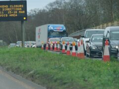 An information sign as traffic builds up in Cobham, Surrey, near to a closed section of the M25 (Yui Mok/PA)