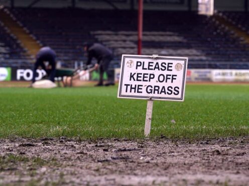 Ground staff work on the pitch at Dens Park (Andrew Milligan/PA)