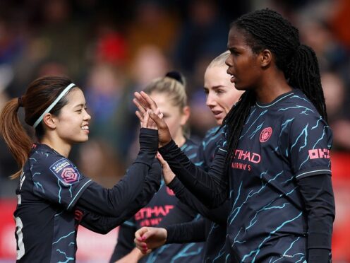 Khadija Shaw (right) celebrates scoring Manchester City’s third goal against Brighton (Steven Paston/PA)