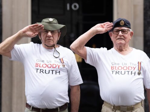 Veterans of Britain’s Cold War radiation experiments Terry Quinlan (left) and Brian Unthank (right) hand a petition in at Downing Street (Stefan Rousseau/PA)