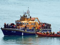 A group of people thought to be migrants are brought in to Dover, Kent, onboard the RNLI Dover Lifeboat following a small boat incident in the Channel (Gareth Fuller/PA)