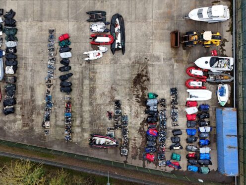 A view of small boats and engines used to cross the Channel by people thought to be migrants at a warehouse facility in Dover, Kent (Gareth Fuller/PA)