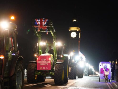 Farmers take part in a tractor ‘go-slow’ near the Palace of Westminster (Jordan Pettitt/PA)