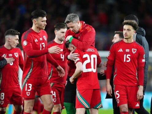 Daniel James is consoled by his Wales team-mates after missing from the spot in a penalty shoot-out against Poland (David Davies/PA)