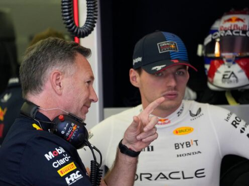 Christian Horner, left, speaks with Max Verstappen in Bahrain (Darko Bandic/AP)