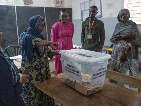 Election officials open ballot boxes before counting the votes in Dakar, Senegal (Sylvain Cherkaoui/AP)
