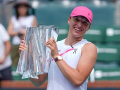 Iga Swiatek, of Poland, holds the trophy after defeating Maria Sakkari, of Greece, in the final match at the BNP Paribas Open. (Ryan Sun/AP)