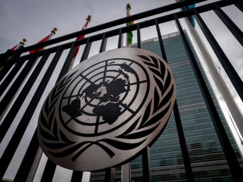 The symbol of the United Nations is displayed on the main gate outside UN headquarters (John Minchillo/AP)