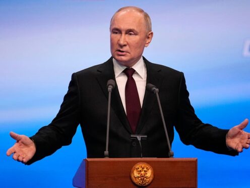 Russian President Vladimir Putin gestures while speaking on a visit to his campaign headquarters after a presidential election in Moscow, Russia (Alexander Zemlianichenko/AP)