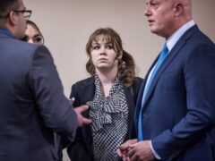 Rust movie armorer Hannah Gutierrez-Reed talks with her lawyer Jason Bowles, right, and her defence team (Jim Weber/Santa Fe New Mexican via AP, Pool)