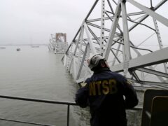 In this image released by the National Transportation and Safety Board, a NTSB investigator is seen on the cargo vessel Dali, which struck and collapsed the Francis Scott Key Bridge (Peter Knudson/NTSB/AP)