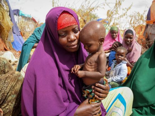Nunay Mohamed, 25, holds her one-year old malnourished child at a makeshift camp for the displaced on the outskirts of Mogadishu, Somalia (AP)
