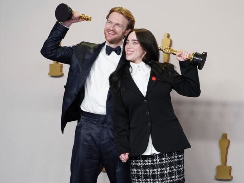 Finneas O’Connell and Billie Eilish pose in the press room with the award for best original song for What Was I Made For?(Jordan Strauss/Invision/AP)