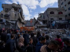Palestinians check destruction after an Israeli strike in Rafah (Fatima Shbair/AP)