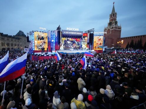 People watch a concert marking the 10-year anniversary of Crimea’s annexation by Russia in Red Square in Moscow (Alexander Zemlianichenko/AP)