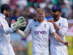 England captain Ben Stokes, centre, celebrates taking the wicket of Rohit Sharma (Ashwini Bhatia/AP)