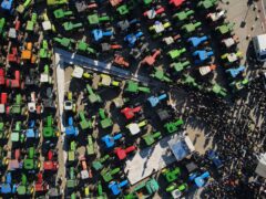Protesting farmers with their tractors take part in a rally outside an agricultural fair in the city of Thessaloniki, northern Greece (Giannis Papanikos/AP)