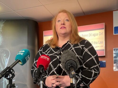 Naomi Long speaks to reporters at the Department of Justice at Stormont (David Young/PA)