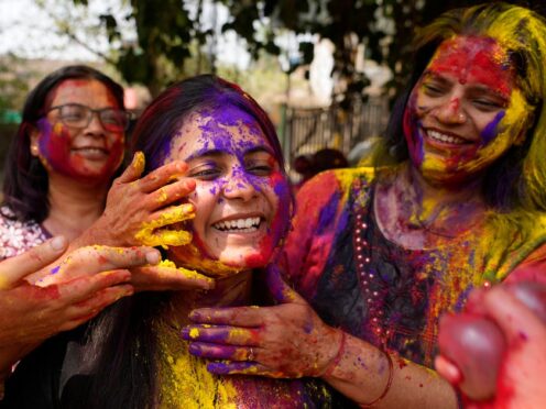 Indian women play with coloured powder during celebrations marking Holi, the Hindu festival of colours (AP Photo/Rajesh Kumar Singh)