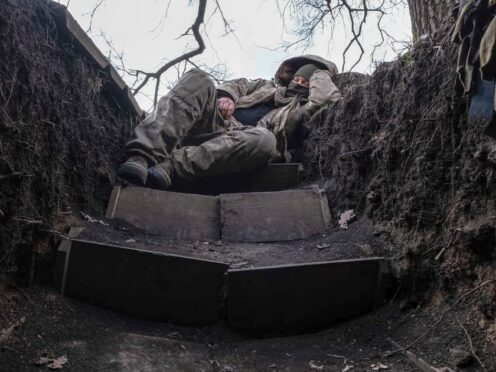 A Ukrainian soldier takes a rest in a trench on the frontline in the Donetsk region (Iryna Rybakova via AP)