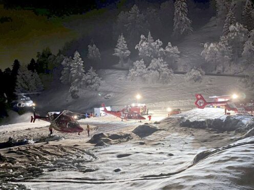 Mountain rescuers and helicopters (Valais cantonal police via AP)