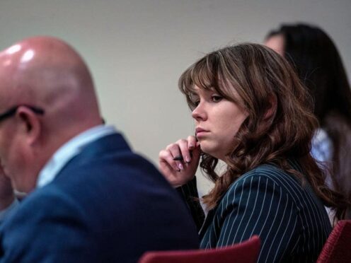 Hannah Gutierrez-Reed, centre, sits with her lawyer Jason Bowles, left (Eddie Moore/The Albuquerque Journal via AP, Pool)