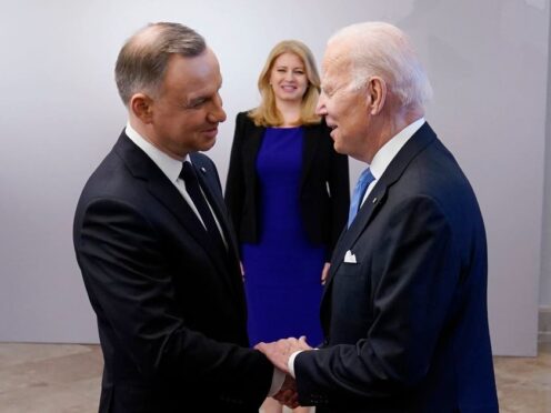 US President Joe Biden, right, is greeted by Polish President Andrzej Duda at the Presidential Palace in Warsaw in February (Evan Vucci/AP)