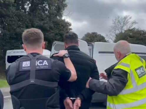 National Crime Agency officers arrest a man in Portsmouth on suspicion of people smuggling (NCA/PA)