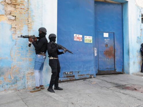 Police stand guard outside the National Penitentiary in Port-au-Prince, Haiti (Odelyn Joseph/AP)