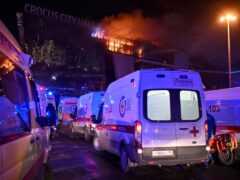 Ambulances park near a burning building of the Crocus City Hall on the western edge of Moscow, Russia (AP Photo/Dmitry Serebryakov)