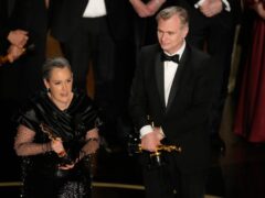 Emma Thomas and Christopher Nolan accept the award for best picture for Oppenheimer (Chris Pizzello/AP)