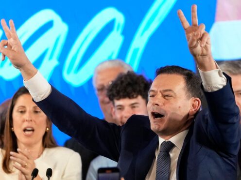 Luis Montenegro, leader of the centre-right Democratic Alliance, gestures to supporters after claiming victory in Portugal’s election (Armando Franca/AP)